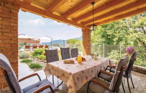 a dining table and chairs on a patio at Villa Ivetta in Veprinac