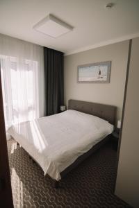 Postel nebo postele na pokoji v ubytování Merepargi ApartHotel & Cafe