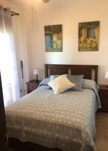 a bedroom with a bed with two bikes on the wall at PLAYA VERDE LUXURY in Ayamonte