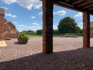 een grote stenen binnenplaats met een grote bakstenen pilaar bij Bainvalley Cottages - Group Accommodation in Lincolnshire