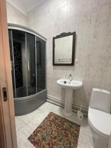 a bathroom with a toilet and a sink and a shower at Гостиница Amulet in Taraz