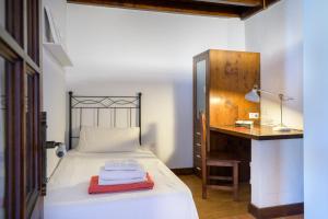 a bedroom with a bed with a desk and a table at Casa Amaia II in Tías