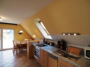 a kitchen with a sink and a table in it at Meer, Whg 15 in Zingst