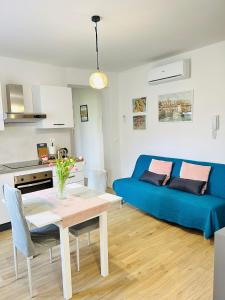 a living room with a blue couch and a table at Casa Divina in Figline Valdarno