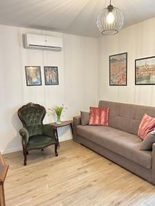 a living room with a couch and a chair at Casa Divina in Figline Valdarno