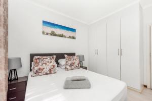 a white bedroom with a white bed and white cabinets at V&S Apartments - Executive Suite in Fourways, Johannesburg in Fourways +23 photos