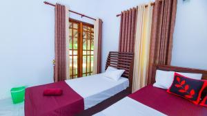a bedroom with two beds and a window at Greenville Resort and Spa in Dambulla