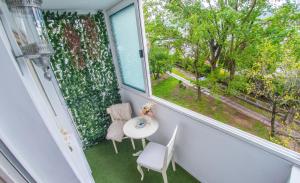 a balcony with a table and two chairs and a window at Luxe Living in Mostar in Mostar