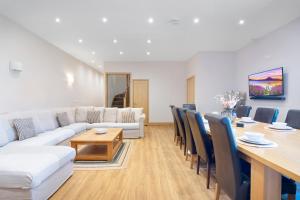 a living room with a white couch and a table at The Roost Group - Meadow Lodge - Hot Tub in Kent