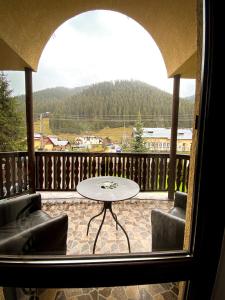 a view of a balcony with a table and chairs at Magura Raraului in Câmpulung Moldovenesc