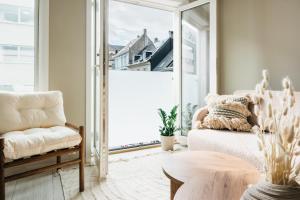 a living room with a couch and a table at Stay Urban - Stylish Scandinavian Gem with French Balcony in Bergen +11 photos