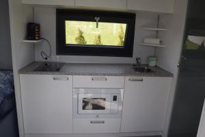 Kuchyň nebo kuchyňský kout v ubytování Tiny House in ruhiger Lage + 8 fotografií