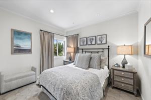 a bedroom with a bed and a chair and a window at Laguna Villa in Laguna Beach