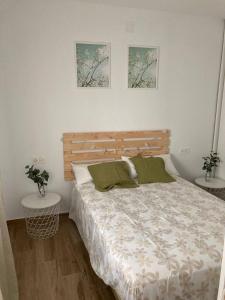 sypialnia z łóżkiem i 2 zdjęciami na ścianie w obiekcie Apartamentos MareaBeach w mieście Torremolinos