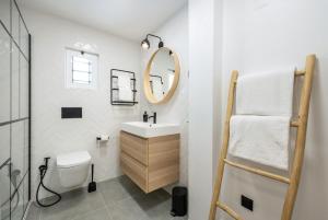 a bathroom with a sink and a toilet and a mirror at Casa Boaz in Carvoeiro +20 photos