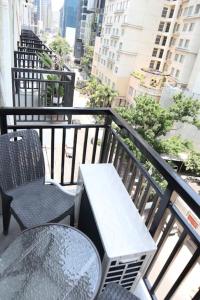 a balcony with a table and chairs on a balcony at Cute 23 sqm condo for the cuties near AYALA CEBU in Cebu City