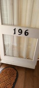 a glass door with numbers on it next to a rug at great holidays hemsby in Hemsby