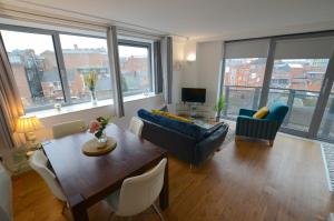 a living room with a couch and a table at Cranbrook House Apartments - Near Ice Arena in Nottingham
