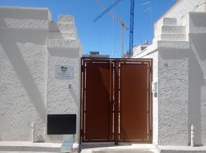 a brown door on the side of a building at Lovin Puglia Vacation in Bari