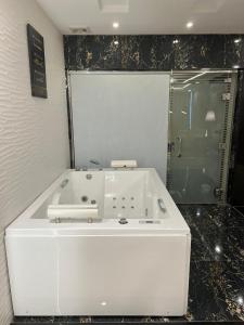 a bathroom with a white sink and a shower at Remaz Suites Hotel in Al Jubail