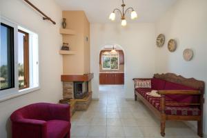a living room with a couch and a fireplace at Villa Ciel in Agios Padeleimon