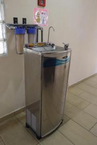 a kitchen sink with a faucet in a room at Hotel Wangsamas in Tampin