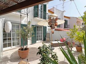 a courtyard with potted plants and a house at Casa Miobelle - Tavira in Tavira