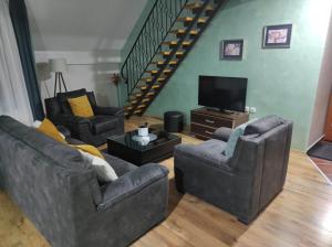 uma sala de estar com dois sofás e uma televisão em Apartments Vila Knez em Zlatibor