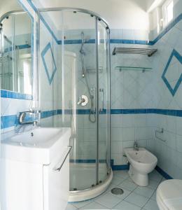 a bathroom with a shower and a sink and a toilet at Albergo La Prora in Capri