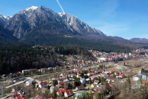 an aerial view of a town in front of a mountain at Vila Roberta in Buşteni