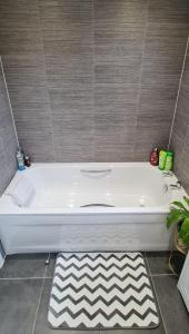 a white bath tub sitting in a bathroom at Magnolia House in Nantwich