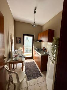 a kitchen with a table and a sink and a table at House No 10 in Olympic Beach +78 photos