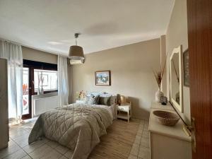 a bedroom with a bed and a table and a window at House No 10 in Olympic Beach