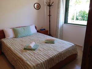 1 dormitorio con 1 cama con 2 toallas en Villa Erato en Palaiokastro