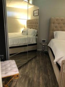 a mirror in a room with two beds and a chair at The Double U Escape in Roseburg