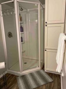 a shower with a glass door in a bathroom at The Double U Escape in Roseburg