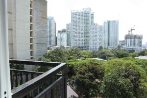 a balcony with a view of a city with tall buildings at Cute 23 sqm condo for the cuties near AYALA CEBU in Cebu City