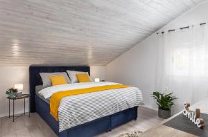 een slaapkamer met een blauw en wit bed met gele kussens bij Apartment Tete Mare in Dubrovnik