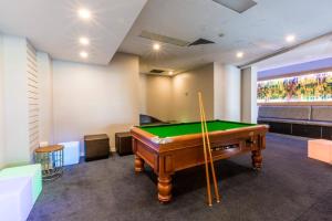 a pool table in a room with a pool cue at Hope Harbour Hotel in Gold Coast