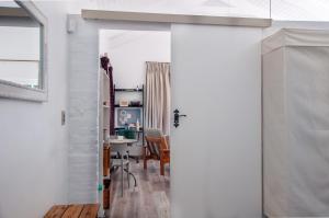 an open door to a room with a desk at The Earthy Inn in Greyton