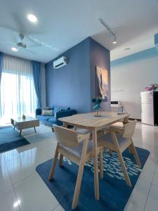 a living room with a wooden table and chairs at Seaview Homestay Masai by Heyday in Masai