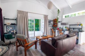 a living room with a couch and a table at The Earthy Inn in Greyton