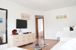 a living room with a tv on a white wall at Apartments Zara in Zadar