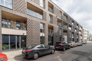 a row of cars parked in front of a building at Deluxe City Studio Kącik 10 by Renters in Krakow