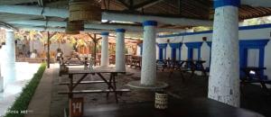 a patio with tables and chairs in a building at Lippo Carita Beach Utara Condo Noah in Carita