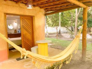 a hammock in front of a house at Chalé Nova Terra in Imbassai