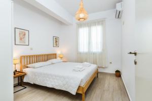Postel nebo postele na pokoji v ubytování Akrotiri Seaside Project