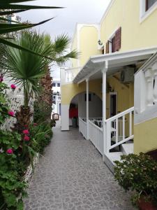 a walkway leading to the front of a building at Christina Pension in Karterados