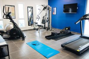 a gym with treadmills and cardio equipment in a room at Twenty Business Flats Nice Angely in Nice