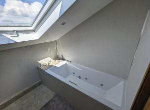 a bathroom with a sink and a window at Treverrows Barn - Barn Conversion on the Farm in Penryn